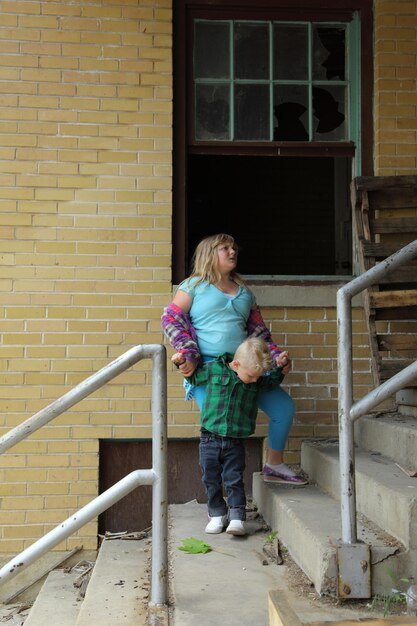 A photo depicting a family being evicted from their home, their belongings piled on the sidewalk, illustrating the human cost of a housing crisis.