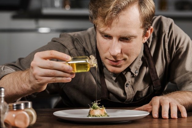 A comical picture of a chef wearing a tall toque, carefully drizzling cannabis-infused oil over a beautifully plated dish at a fancy pop-up restaurant.