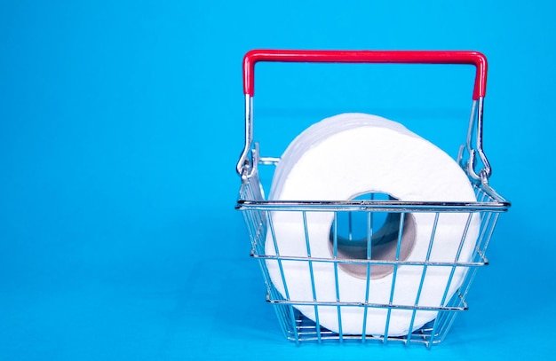 A photograph of an almost empty toilet paper aisle in a supermarket, taken from a low angle, emphasizing the lack of product and the worried expressions of shoppers in the background.